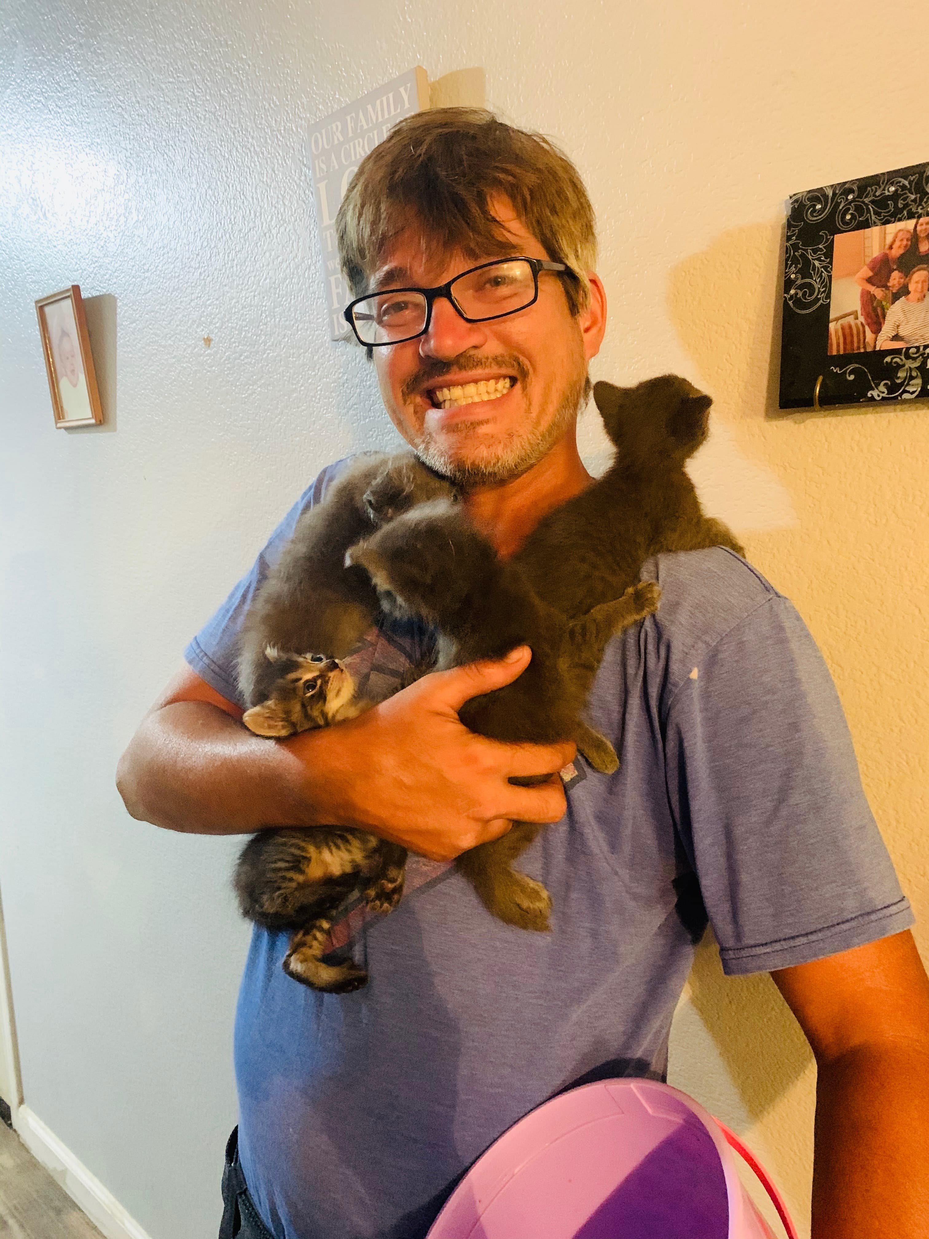 Animal Angel Services team member holding kittens